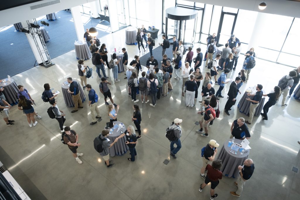 Photo taken from a balcony overlooking a group of people.
