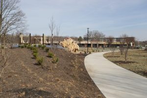 Squirrel Park landscaping with a playground in the distance.