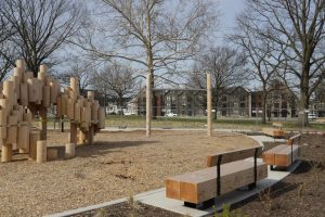 Squirrel Park playground in mulch, with benches lining the perimeter.