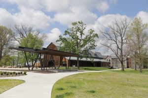 Beck Barn, a large historic barn recently restored and modernized, surrounded by bare autumn trees in fall.